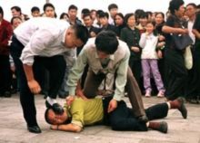 Các cảnh sát mật bắt giữ một học viên Pháp Luân Công trên Quảng trường Thiên An Môn, vào khoảng năm 2000.