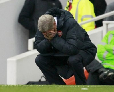 HLV Wenger bưng mặt thất vọng trong trận thua Tottenham.