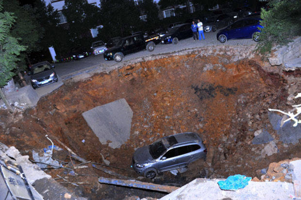 Một chiếc xe hơi sa xuống hố khổng lồ ở tỉnh Quý Châu, Trung Quốc.