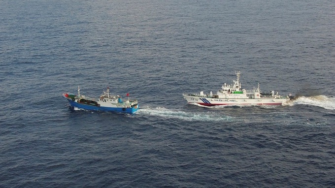 A Chinese fishing boat (L) is pursued by a Japan Coast Guard vessel in waters off Miyako Island, Okinawa prefecture, in this handout  released by 11th Regional Coast Guard Headquarters-Japan Coast Guard February 2, 2013. Japan's coast guard detained the boat near the southern Japanese island of Okinawa on Saturday and arrested the captain for collecting coral illegally, a coast guard official said. The vessel was detained off Miyako Island, some 150 km (95 miles) from islands in the East China Sea known as the Senkaku in Japan and the Diaoyu in China at the centre of a territorial dispute between the two countries, and about 400 km (250 miles) east of Taipei. Mandatory Credit  REUTERS/11th Regional Coast Guard Headquarters-Japan Coast Guard/Handout (JAPAN - Tags: POLITICS TPX IMAGES OF THE DAY)  FOR EDITORIAL USE ONLY. NOT FOR SALE FOR MARKETING OR ADVERTISING CAMPAIGNS. THIS IMAGE HAS BEEN SUPPLIED BY A THIRD PARTY. IT IS DISTRIBUTED, EXACTLY AS RECEIVED BY REUTERS, AS A SERVICE TO CLIENTS. MANDATORY CREDIT