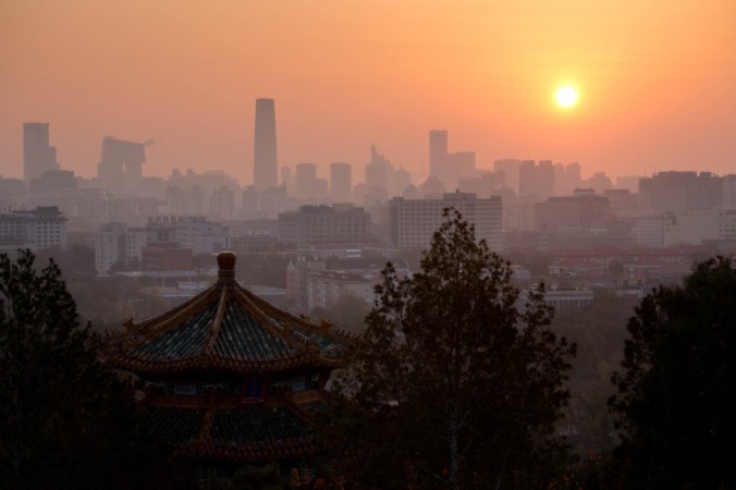 The sun rises above the Beijing skyline early on Nov. 6, 2012. The Chinese Communist Party will collapse in three stages in the next three years and its reign will come to an end by 2016, according to the Hong Kong magazine Frontline. (Ed Jones/AFP/Getty Images)