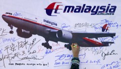 A woman writes a message on a board in Kuala Lumpur