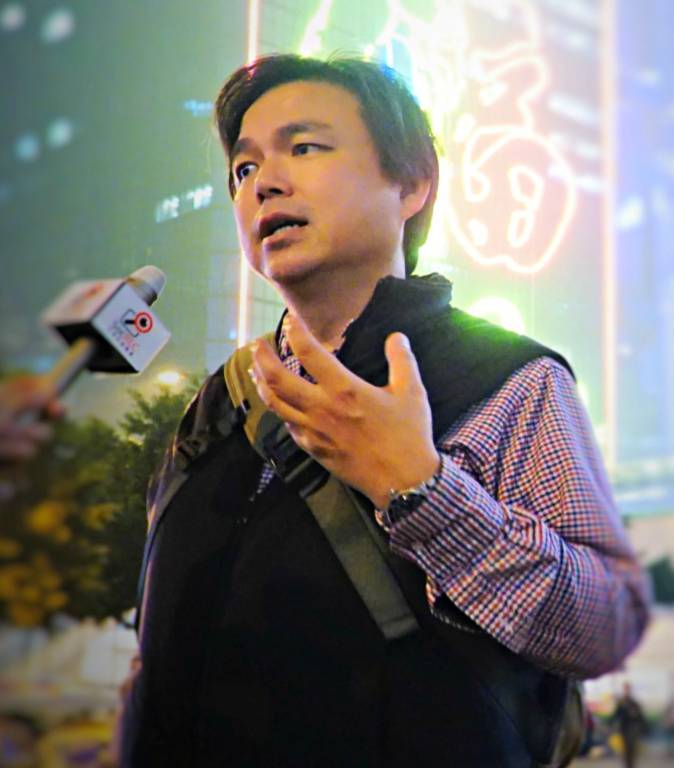 Democracy activist and financier Edward Chin speaks in front of the press in Hong Kong, in this undated photo. He believes big business will leave the country if Beijing keeps disregarding Hong Kong's Basic Law. (Courtesy of Edward Chin)