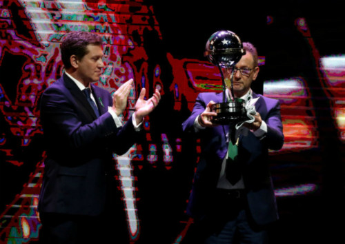 Plinio David de Nes Filho (R), new president of Brazils Chapecoense, receives the champion trophy of the 2016 Copa Sudamericana from Alejandro Dominguez