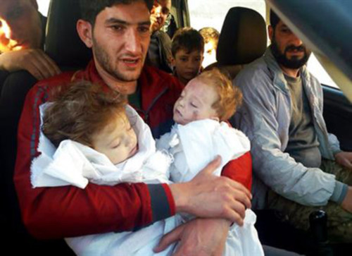 [Cap SAbdul-Hamid Alyousef, 29, holds his twin babies who were killed during a suspected chemical weapons attack, in Khan Sheikhoun in the northern province of Idlib, Syria. Alyousef also lost his wife, two brothers, nephews and many other family members in the attack that claimed scores of his relatives. 