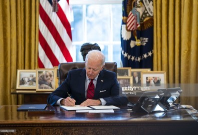 U.S. President Joe Biden signs executive actions in the Oval Office of the White House in Washington, D.C., U.S., on Thursday, Jan. 28, 2021. Biden will make it easier for Americans to buy health insurance during the pandemic, reopening the federal Obamacare marketplace with an order that's a step toward reinvigorating a program his predecessor tried to eliminate. Photographer: Doug Mills/The New York Times/Bloomberg via Getty Images